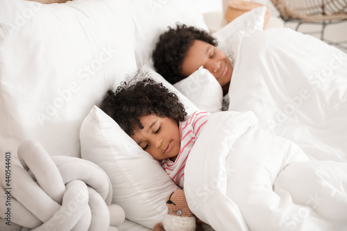African-American children lying in bed