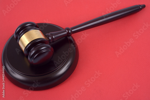 Tablou pe pânză Marteau de juge sur son socle en gros plan sur fond rouge