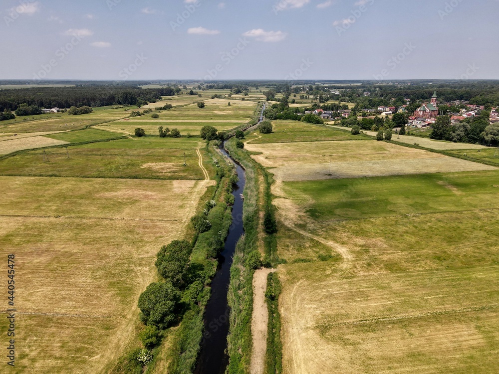 Fields, meadows in rural green areas by the river - top view 