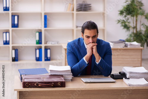 Extremely tired young male employee in the office