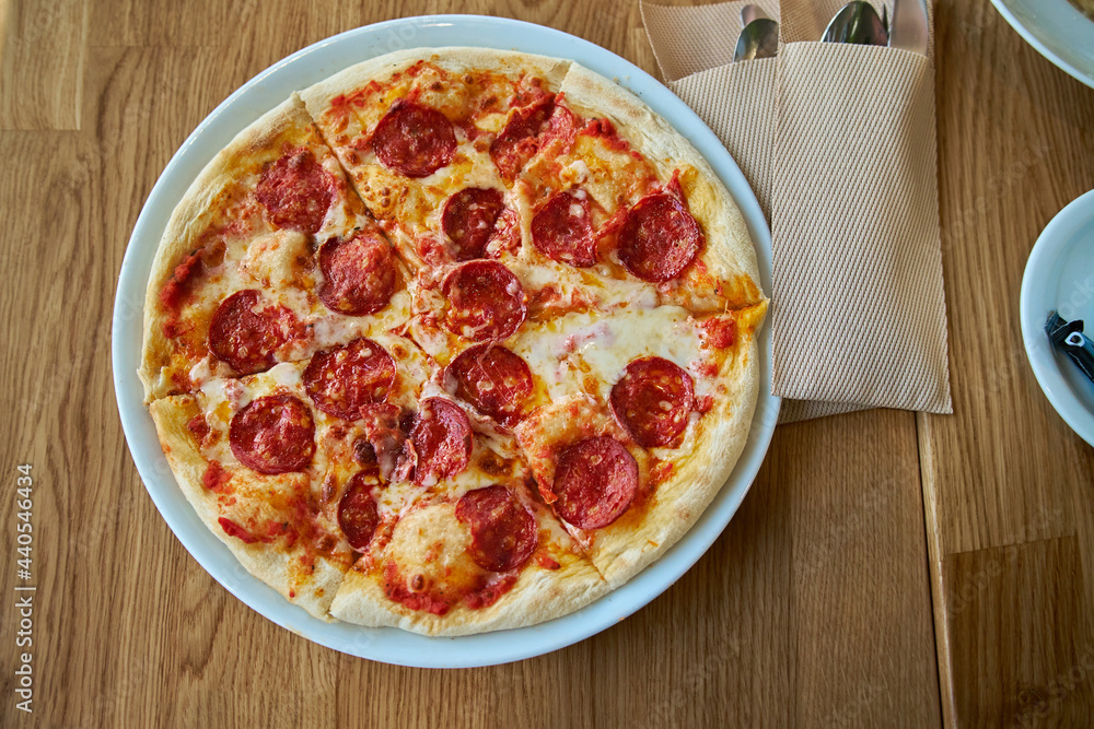 Top view of Pepperoni pizza on plate on the table Top view of Pepperoni pizza on plate on the table