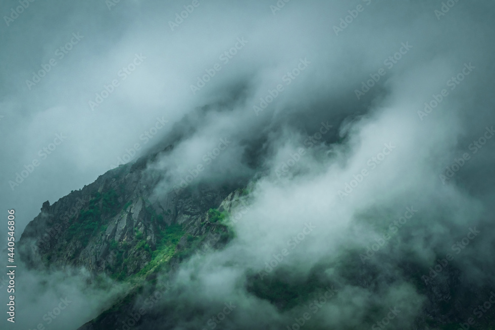 Landscape photograph of mountains being covered by monsoon clouds