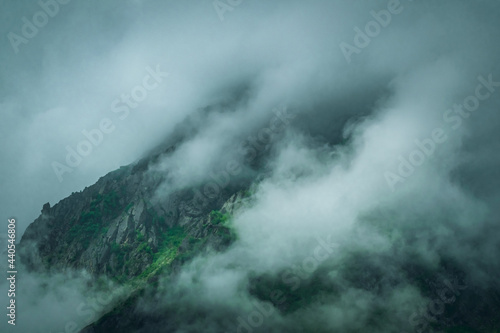 Landscape photograph of mountains being covered by monsoon clouds