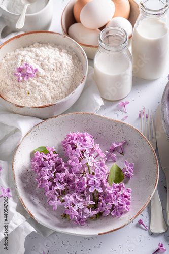 Ingredients for fried lilac flower with powdered sugar. Sweet snack.