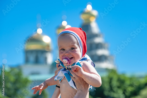 Happy baby in front of a Christian orthodox church in istra