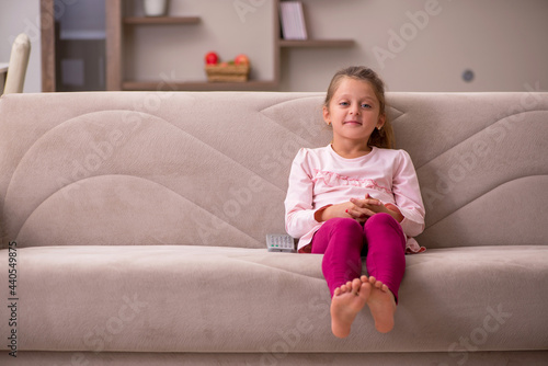 Small girl staying alone at home