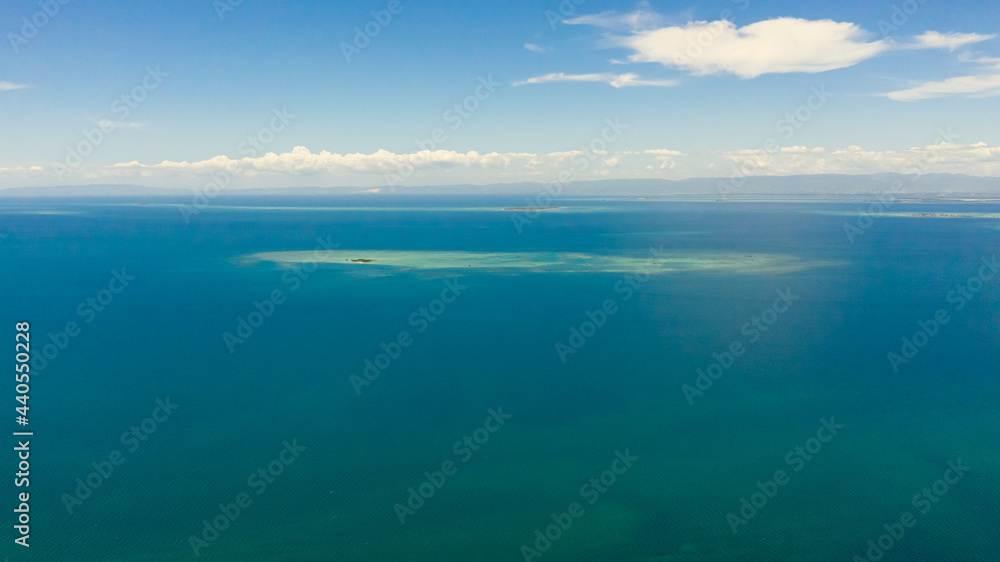 Aerial view of tropical Islands with beaches in the blue sea against the sky and clouds.