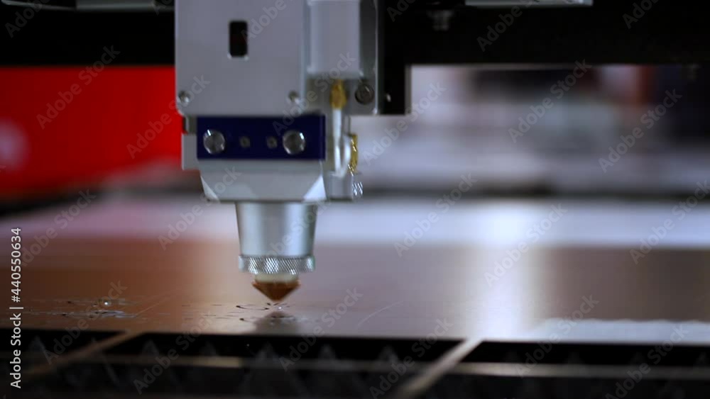 Factory machine Laser CNC cut of metal with light spark. Blue color, technology industrial modern. Factory machine Laser CNC cut of metal with light spark. Blue color, technology industrial modern.