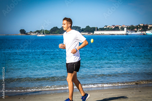 man running on the beach sand