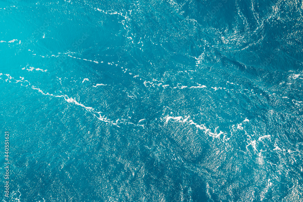 Turquoise ocean water background. Surface of the sea. Natural texture of blue foaming sea water. Turquoise ocean water background. Surface of the sea. Natural texture of blue foaming sea water.