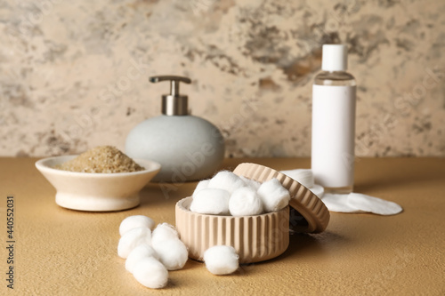 Container with soft cotton wool on table in bathroom