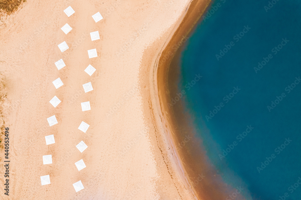 Concept travel and vacation summer. Beach and blue water waves seascape background from aerial top view