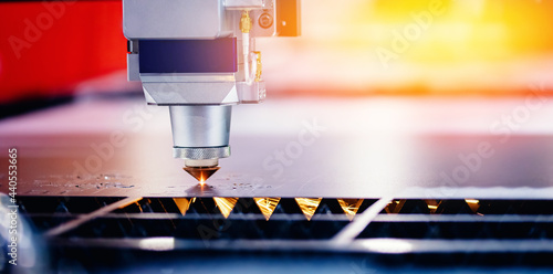 Concept banner background modern industrial technology. CNC Laser engraving cutting of heavy metal with light spark