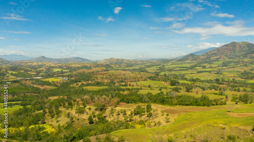 Farmland with growing crops of rice, vegetables and sugar cane in a mountain valley. Mindanao, Philippines.