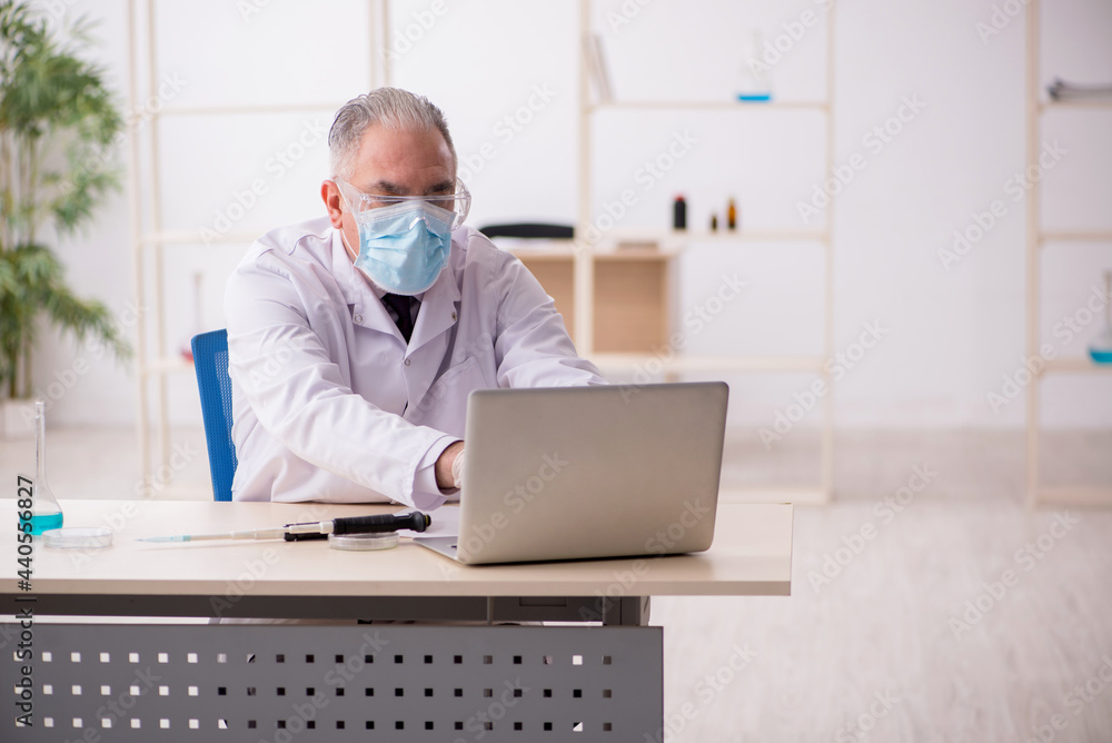 Old male chemist working in the lab during pandemic Old male chemist working in the lab during pandemic