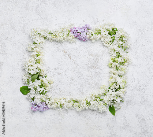 Frame made of beautiful lilac flowers on light background
