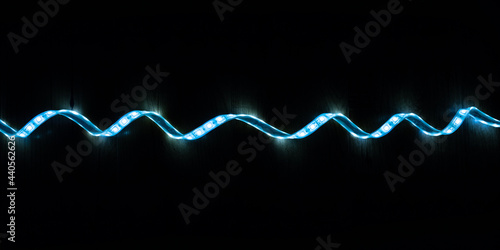 LED strip with cold blue light on a black background