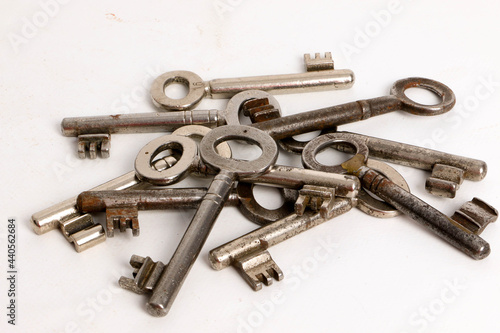 heap of many different old keys are lying in the whiite studio