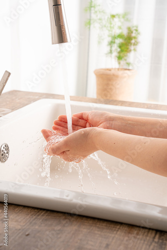Washing hands with flowing water in the sink