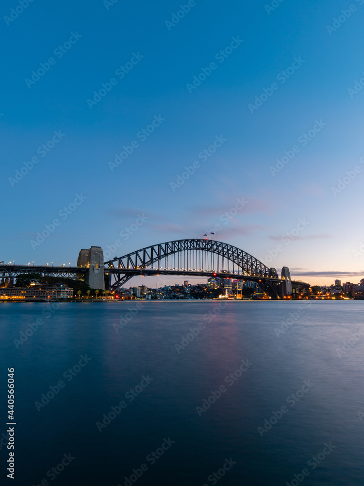 Dawn view of Sydney Harbour Bridge with clear sky.