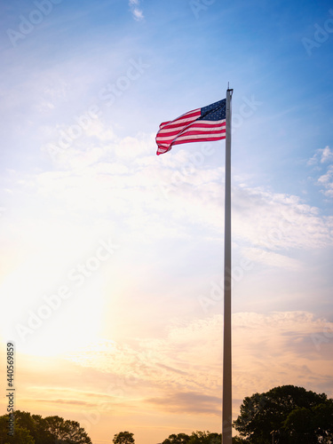 American Flag at Dawn. Rising Sun and Waving Flag. Sign for Hope and Promises.