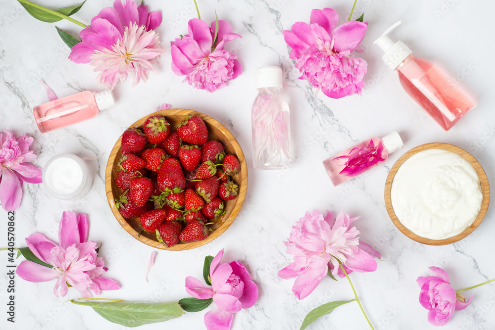 strawberry face mask. essential oils, beautiful peonies on a white marble background. Flat lay, top view. facial skin care, beauty spa treatment concept strawberry face mask. essential oils, beautiful peonies on a white marble background. Flat lay, top view. facial skin care, beauty spa treatment concept