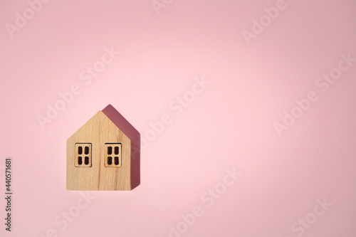 Wooden house model on pink ...