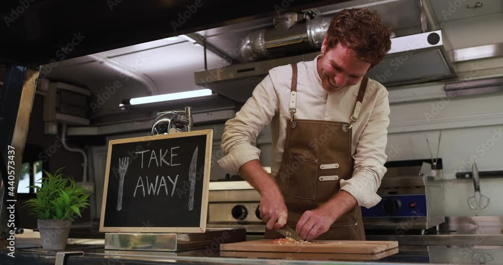 Young chef man working inside food truck preparing dinner food - Summer job concept Young chef man working inside food truck preparing dinner food - Summer job concept