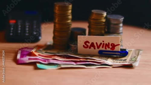 Indian coin with cash on table saving money text,indian coin-cash on wooden table rotating,saving concept,coins and indian note (cash) with text label