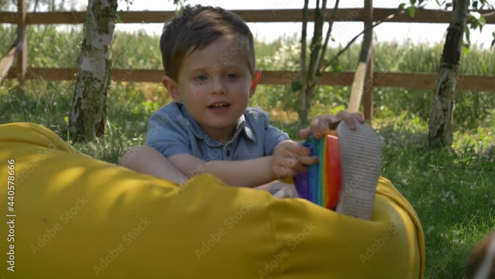 Little boy play with pop it toy in outdoor