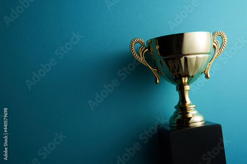 golden trophy on blue background photo
