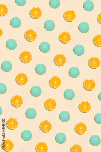 Creative summer fruit idea with halved fresh organic orange painted blue. Minimalistic flat lay pattern composition, vertical linear arrangement, healthy food concept.