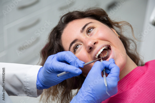 Closeup of dentist working on a girl's mouth.