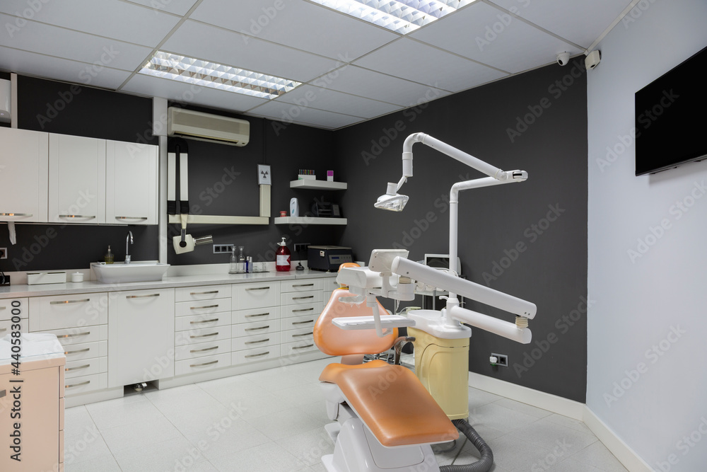 Interior dental clinic with dark gray wall.