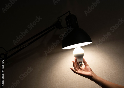 man is changing the reading lamp
