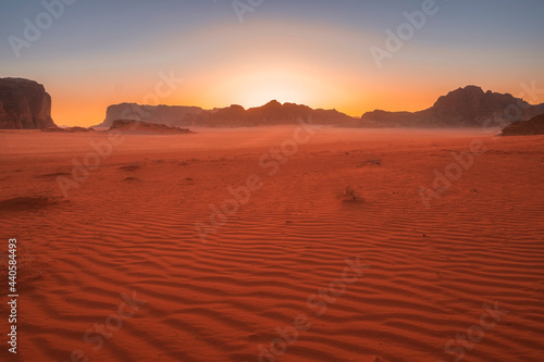 Beautiful sunset in the red desert of Wadi Rum in Jordan with patterns on the sand
