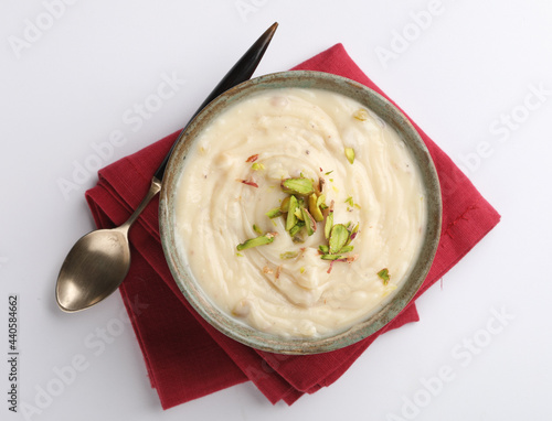 Shrikhand is an Indian sweet dish made of strained yogurt, garnished with dry fruits and saffron.  photo