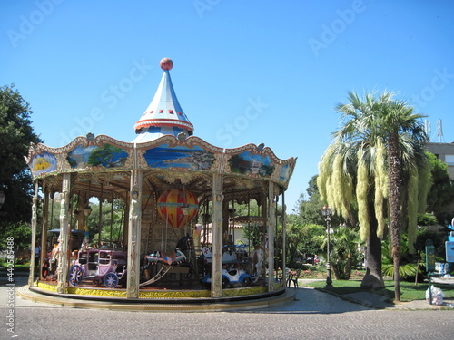 Beautiful carousel with horses in urban park