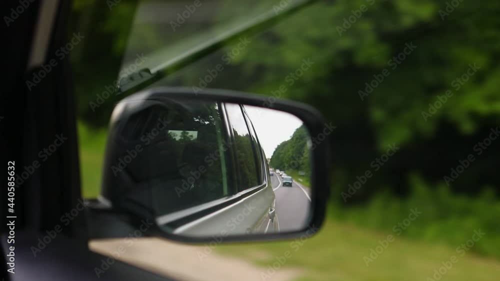 view of speedway in rear car reflection view of speedway in rear car reflection