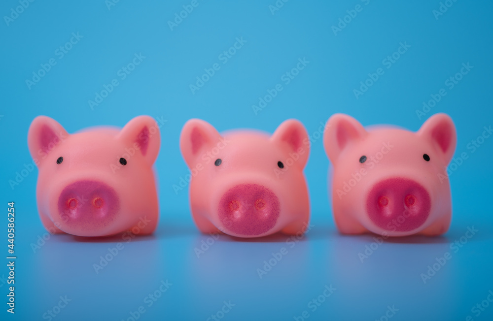 Pink pigs on a blue background. Holiday background for the calendar. Pink pigs on a blue background. Holiday background for the calendar.