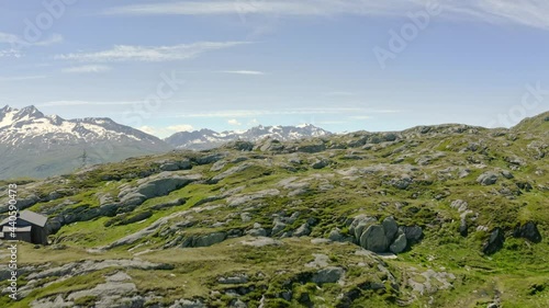 Forward aerial climb over mountain ridges to reaveal high peaks in the Swiss alps, filmed from Grimsel Pass photo