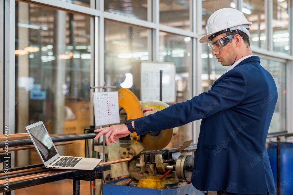 The factory manager using laptop. Engineers and technicians are working in industrial plants. The factory manager using laptop. Engineers and technicians are working in industrial plants.