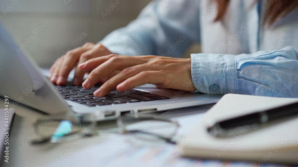 Young woman sitting at living room and working on laptop at home Young woman sitting at living room and working on laptop at home