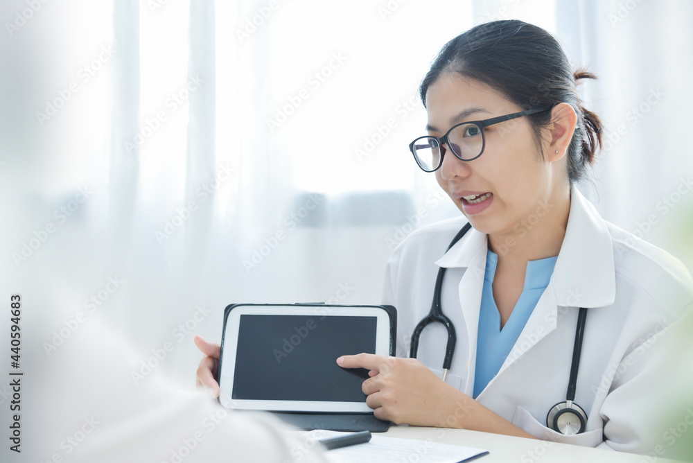 Asian Female Doctor or nurse using digital tablet in a meeting Asian Female Doctor or nurse using digital tablet in a meeting