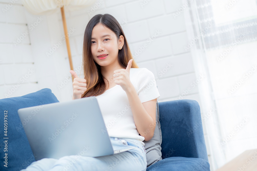 Young asian business woman smile and work from home with laptop computer online to internet on sofa in living room, freelance girl using notebook on couch with comfort, new normal, lifestyle concept. Young asian business woman smile and work from home with laptop computer online to internet on sofa in living room, freelance girl using notebook on couch with comfort, new normal, lifestyle concept.