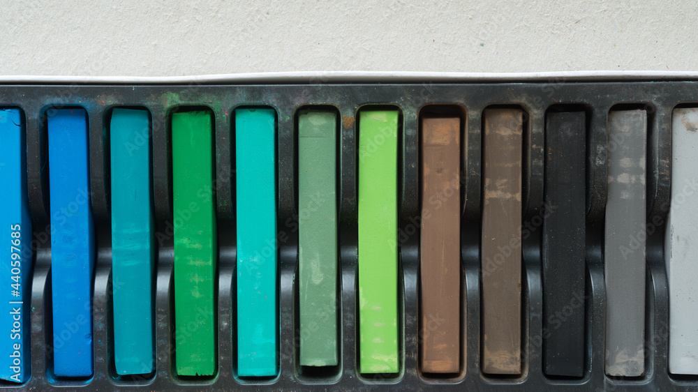 close up of chalk pastes in blue green brown and black close up of chalk pastes in blue green brown and black