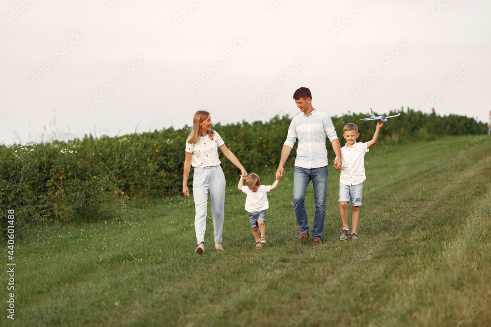 Family walks in a field and playing with toy plane Family walks in a field and playing with toy plane