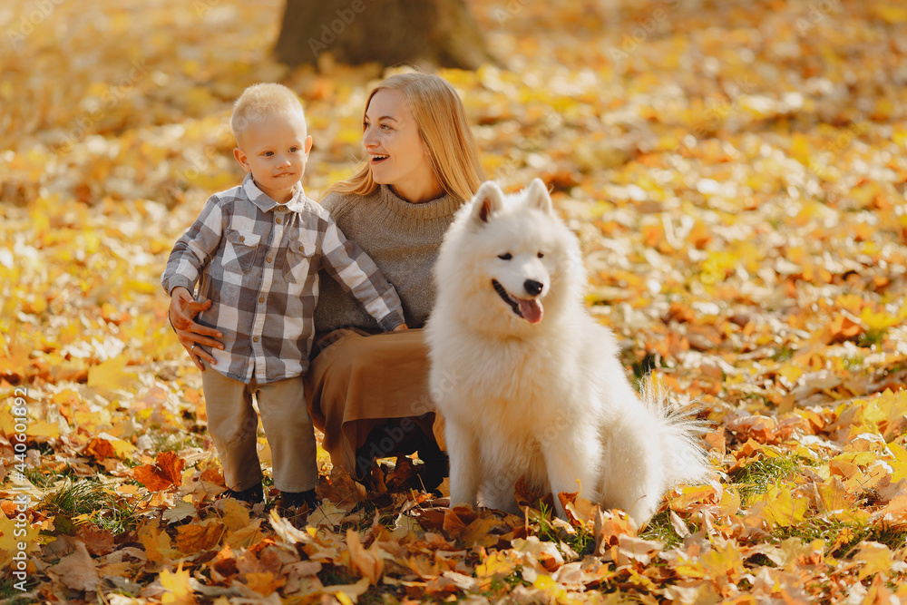 Mother with little son sitting in a autumn field Mother with little son sitting in a autumn field