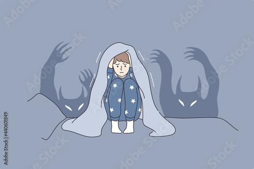Children nightmares and fears concept. Afraid kid cartoon character sitting in bed covering head with blanket afraid of ghosts and hiding in bed vector illustration 