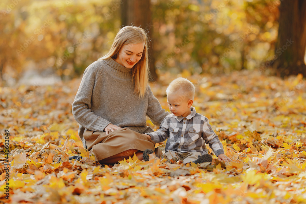 Mother with little son playing in a autumn field Mother with little son playing in a autumn field